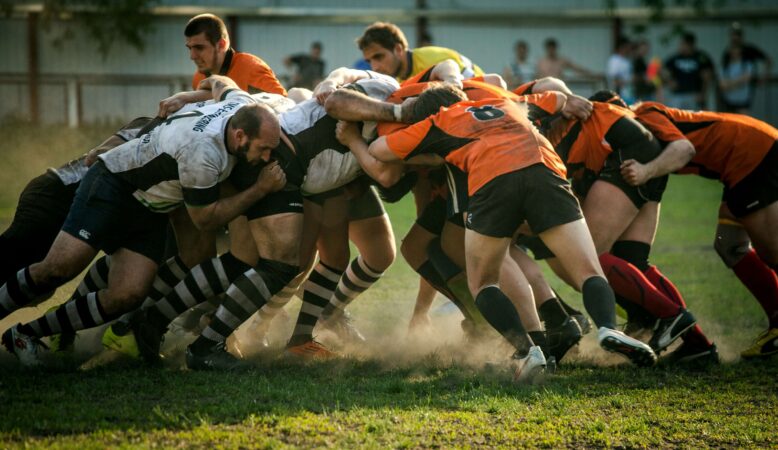 group-of-men-playing-a-rugby-game-in-the-field-clashing